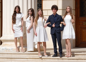 Boy posing with four girl on stairs